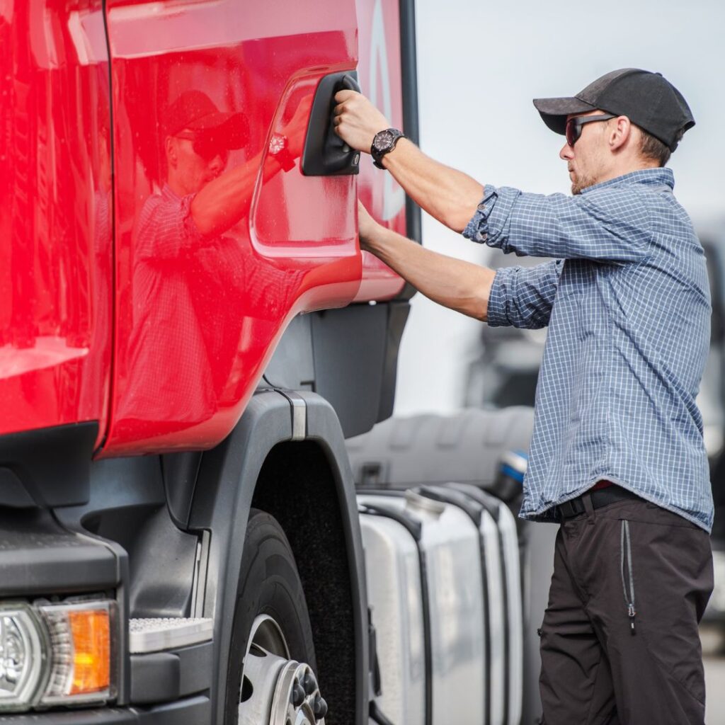 Semi-truck driver opening cab door